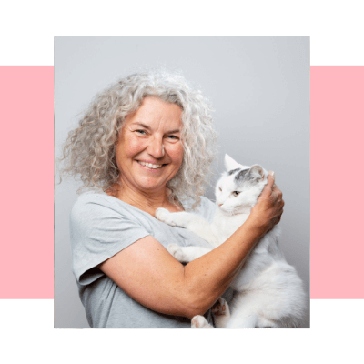 An image of a happy woman holding a cat